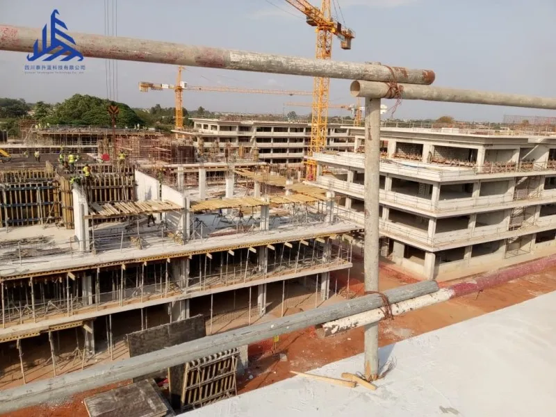 Wide view of a multi-block construction project in Benin using Taishenglan slab formwork systems, steel props, and H20 timber beams